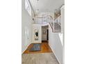 Bright foyer with hardwood floors, a staircase, and a view of the upper level, creating an inviting entrance at 19431 E Hamilton Pl, Aurora, CO 80013