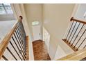 Bright foyer features hardwood floors and a view of the front door from the upper level at 2454 Ambience Ln, Castle Rock, CO 80109