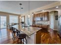 Eat-in kitchen featuring an island with granite countertops and stainless steel appliances at 7472 Iridium Way, Castle Rock, CO 80108