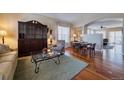 Cozy living room featuring hardwood floors and an antique hutch at 7472 Iridium Way, Castle Rock, CO 80108