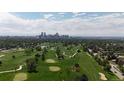 Breathtaking aerial view showcasing a lush golf course against the backdrop of the city skyline at 2626 N Steele St, Denver, CO 80205