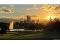 Beautiful sunrise over the city skyline and lake, creating a picturesque and inviting atmosphere at 2626 N Steele St, Denver, CO 80205