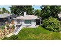 Charming home showcasing a well-maintained lawn, brick exterior, and a stairway leading up to the front door at 2626 N Steele St, Denver, CO 80205