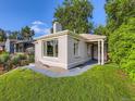 Home featuring a well-maintained lawn, modern gray exterior, and inviting front entrance at 2626 N Steele St, Denver, CO 80205