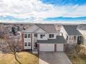 Aerial view of home with brick accents, three-car garage, in a residential neighborhood at 5797 S Shawnee St, Aurora, CO 80015