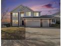 Beautiful home featuring a three-car garage, brick accents, at sunset at 5797 S Shawnee St, Aurora, CO 80015