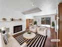 Virtually staged living room with fireplace and hardwood floors at 3850 Paseo Del Prado # 7, Boulder, CO 80301