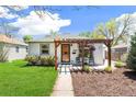 Inviting front porch with pergola, seating, and well-maintained landscaping enhances this home's curb appeal at 2252 Lamar St, Edgewater, CO 80214