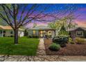 Twilight view of a charming single-story home featuring a manicured lawn and inviting front porch at 2252 Lamar St, Edgewater, CO 80214