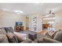 Comfortable living room featuring neutral walls, a large rug, and an open floor plan at 2252 Lamar St, Edgewater, CO 80214
