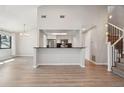 Bright open-concept living space with modern flooring adjacent to the updated kitchen area at 540 S Forest St # 3-204, Denver, CO 80246