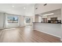 Open living room with hardwood floors, a large window and an open design to the kitchen at 540 S Forest St # 3-204, Denver, CO 80246