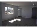 Bright living room featuring an open floorplan, neutral paint colors and arched doorways at 9191 Russell Way, Thornton, CO 80229