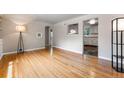 Bright living room showcasing hardwood floors, archways, and an adjacent kitchen at 1535 Hudson St # 1, Denver, CO 80220