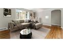 Comfortable living room featuring a large sectional, neutral tones, and wood floors at 1535 Hudson St # 1, Denver, CO 80220