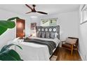 Bright main bedroom with hardwood floors, ceiling fan, and comfortable seating area for relaxation at 4100 Shaw Blvd, Westminster, CO 80031