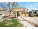 Charming two-story home boasts a three-car garage, covered porch, and well-maintained landscaping at 6173 Eldora St, Golden, CO 80403