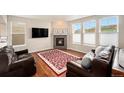Comfortable living room with hardwood floors, fireplace, and large windows at 6173 Eldora St, Golden, CO 80403