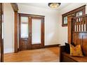 Elegant foyer with hardwood floors, vintage light fixture, and charming stained-glass window at 1430 Monroe St, Denver, CO 80206