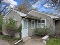 The property features a cozy entryway with a white door and a small stone bench at 1950 Glen Shiel Dr, Lakewood, CO 80215