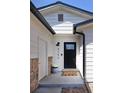 Inviting front entrance with a decorative black door and stone veneer at 4793 S Swadley St, Morrison, CO 80465