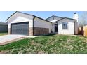 Charming exterior of a home featuring a two-car garage and stone accents at 4793 S Swadley St, Morrison, CO 80465