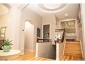Hallway with hardwood floors, stairs with railing, and decoratively painted neutral-colored walls at 226 Hidden Valley Ln, Castle Rock, CO 80108