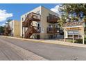 Exterior view of condominiums featuring private balconies and wooden staircases with 