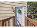 Close up of the front door of the unit with green wreath hanging from the front at 9240 W 49Th Ave # 317, Wheat Ridge, CO 80033