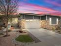 Charming home features a stone facade, neutral paint, and a two-car garage with a long driveway at 4538 Hidden Gulch Rd, Castle Rock, CO 80104