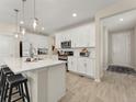 Bright kitchen with white cabinets, subway tile backsplash, and a center island with pendant lighting at 4538 Hidden Gulch Rd, Castle Rock, CO 80104