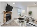 Living room with fireplace and light flooring at 932 S Dearborn Way # 8, Aurora, CO 80012