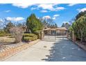 Beautiful exterior showcasing a gated driveway, mature landscaping, and inviting curb appeal at 5274 Idylwild Trl, Boulder, CO 80301