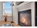 Close up of a warm fireplace with a sleek black trim and beautiful natural light at 2428 W 82Nd Pl # 3A, Westminster, CO 80031