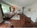 Bright living room with hardwood floors, a large window, and comfortable seating at 8610 Jolene Dr, Denver, CO 80229