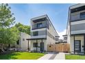Modern three-story home with a balcony, landscaped front yard, and contemporary design at 1713 Grove St, Denver, CO 80204