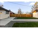 A backyard featuring a concrete patio, green grass, and gravel at 3250 N Clayton St, Denver, CO 80205