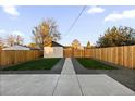 A backyard featuring a concrete patio, green grass, and gravel at 3250 N Clayton St, Denver, CO 80205