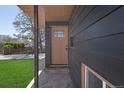 Inviting front door with brick landing on a modern-style home at 6641 Ash St, Commerce City, CO 80022