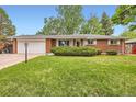 Charming single-story brick home with a well-manicured lawn and attached garage at 13558 E Center Ave, Aurora, CO 80012