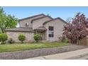 Beautiful two-story home featuring well-manicured lawn, gravel accents, and mature trees at 401 W 114Th Pl, Northglenn, CO 80234