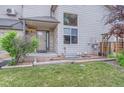Inviting front porch with well-maintained lawn, tidy landscaping, and gray siding accents at 401 W 114Th Pl, Northglenn, CO 80234