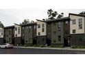 Modern townhome exterior with multi-tone facade and clean lines, set on a well-maintained street at 8410 W 52Nd Ave, Arvada, CO 80002