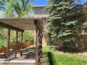 Picturesque backyard featuring a wooden pergola with outdoor seating, complemented by a well-manicured lawn at 1607 Cottonwood Dr # 14, Louisville, CO 80027