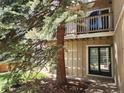 Inviting condo with a private balcony and a cozy entrance, surrounded by mature trees and natural landscaping at 1607 Cottonwood Dr # 14, Louisville, CO 80027