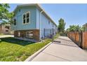A charming, blue two-story home with a gated driveway at 8160 W 81St Pl, Arvada, CO 80005