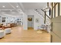 Bright foyer with staircase, light hardwood floors and open floor plan at 1343 Milwaukee St, Denver, CO 80206