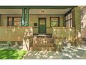 Inviting front porch with brick pillars and a classic green door at 1343 Milwaukee St, Denver, CO 80206