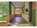 Spacious porch featuring brick detail, a dark wood floor and ample light at 1343 Milwaukee St, Denver, CO 80206