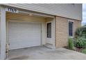 Attached one car garage with white door next to front entryway at 1769 S Lee St # B, Lakewood, CO 80232